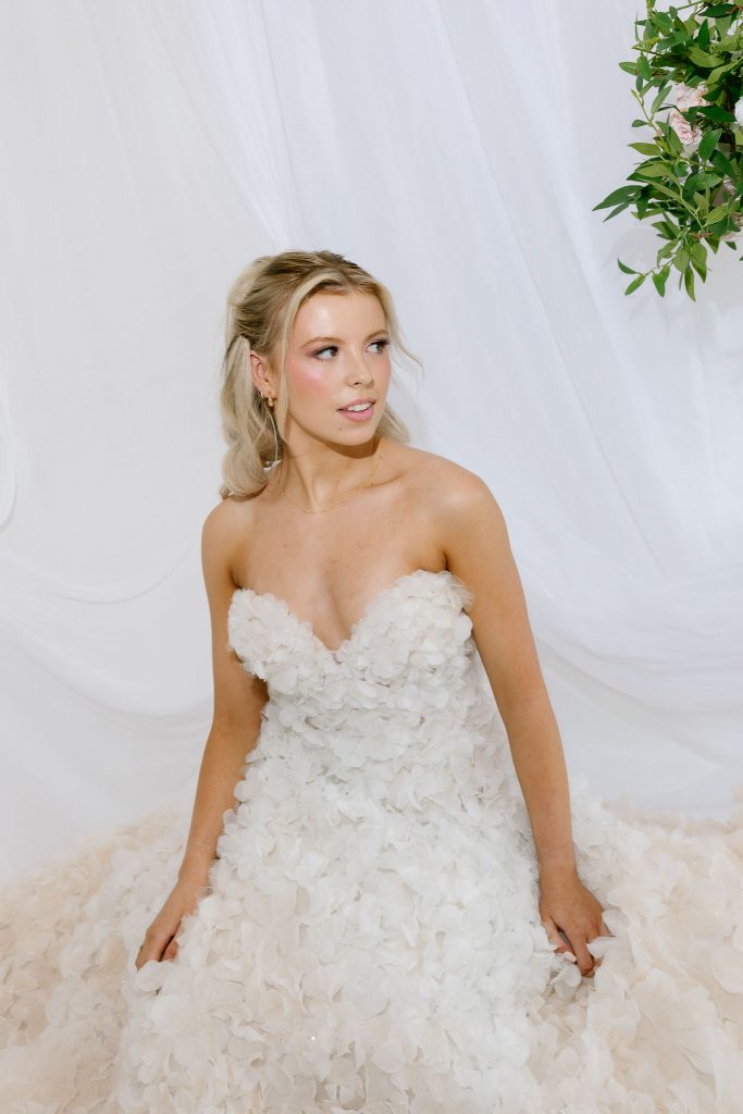 Scottish bridal styling with luminous makeup and flowing half up curls on a blonde model, all created by hair and makeup artist Hannah Bailey in Glasgow.
