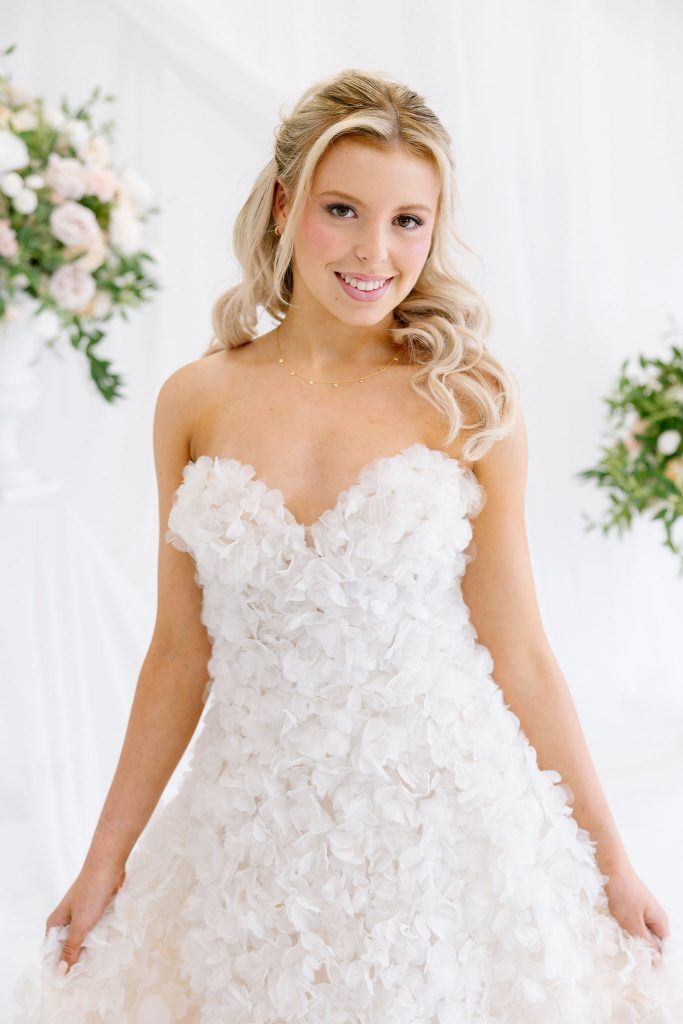 Soft bridal half up hairstyle with cascading curls and glowing makeup on a blonde model for a Scottish wedding directory portfolio shoot.